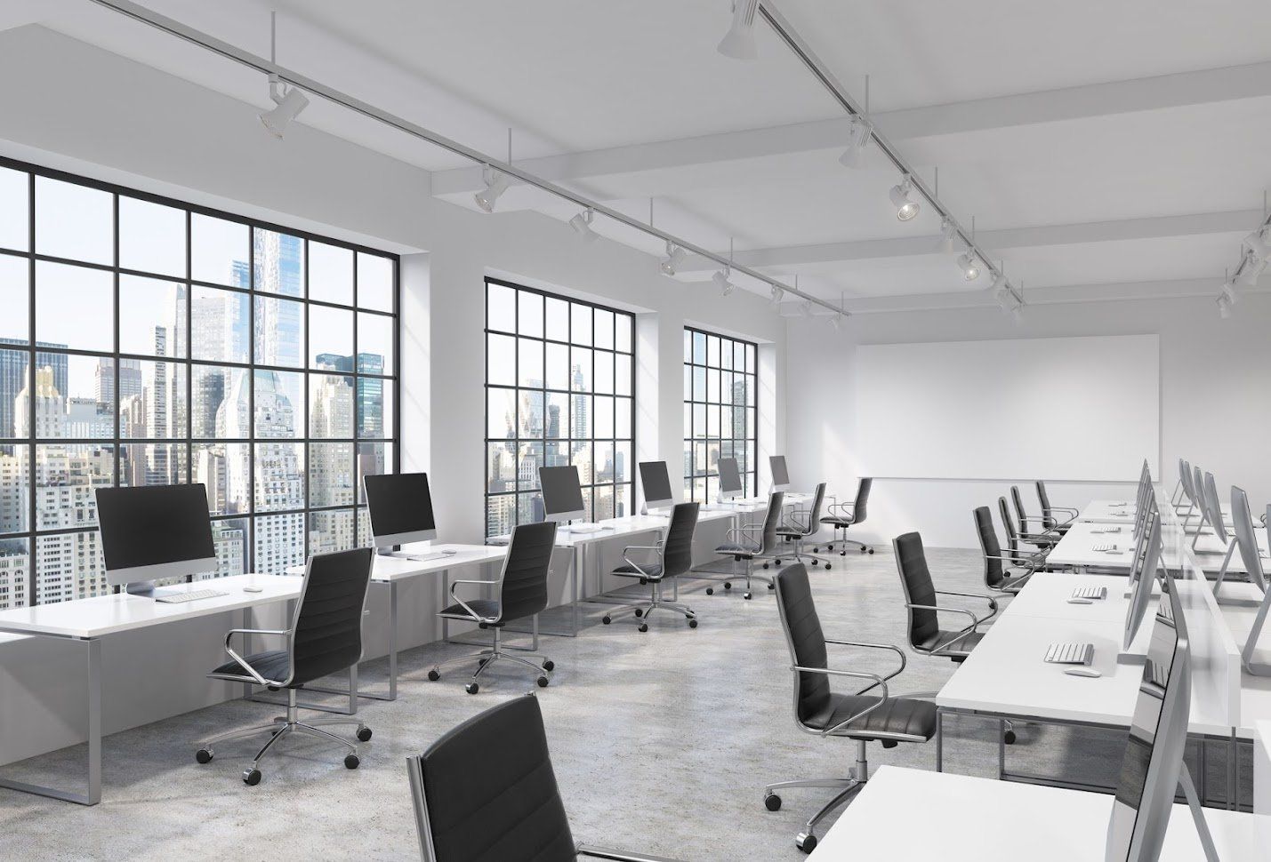 Spacious and bright modern office interior with rows of desks and computers, set against the backdrop of a city skyline.