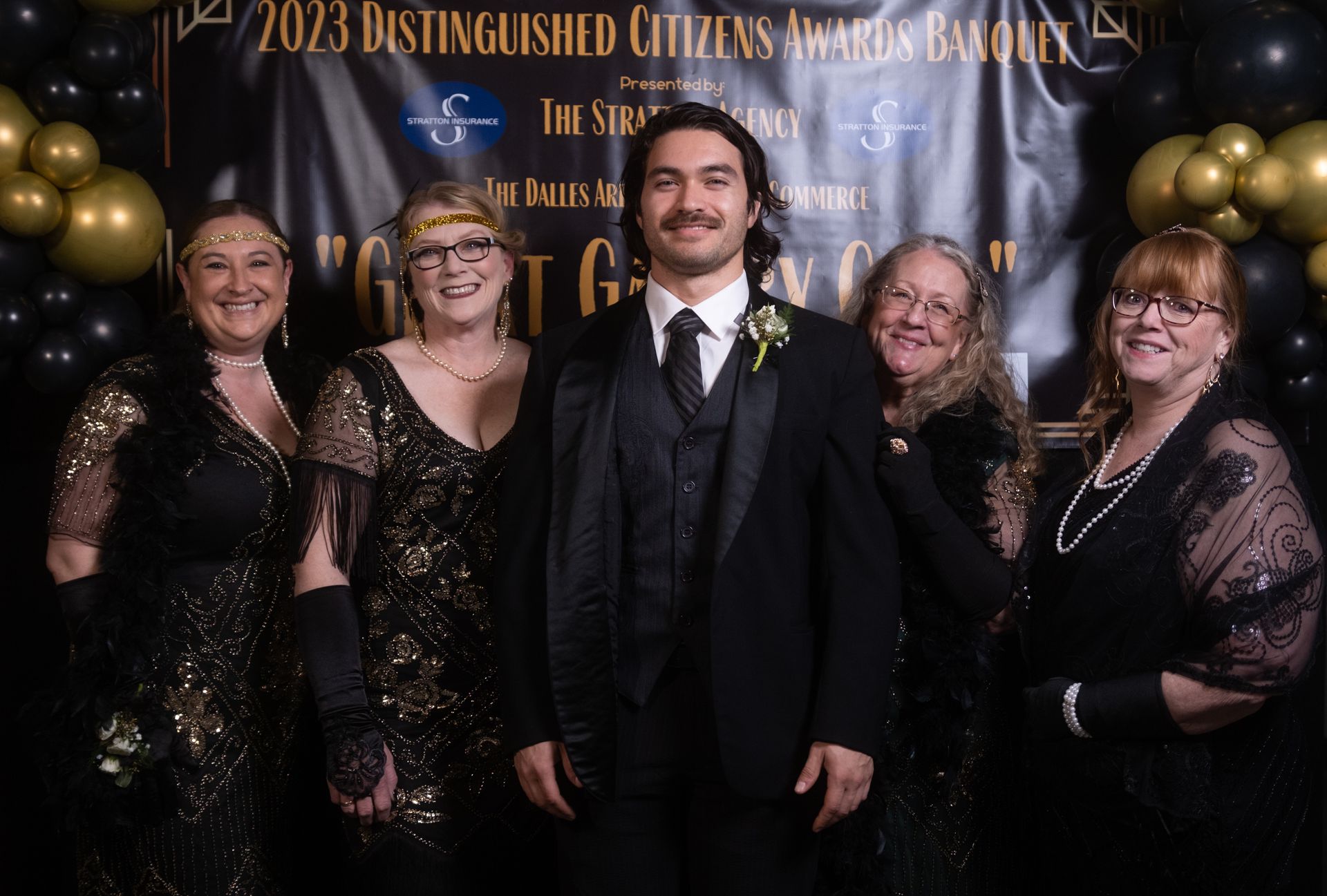 A group of people are posing for a picture in front of a sign that says 2023 distinguished citizens awards