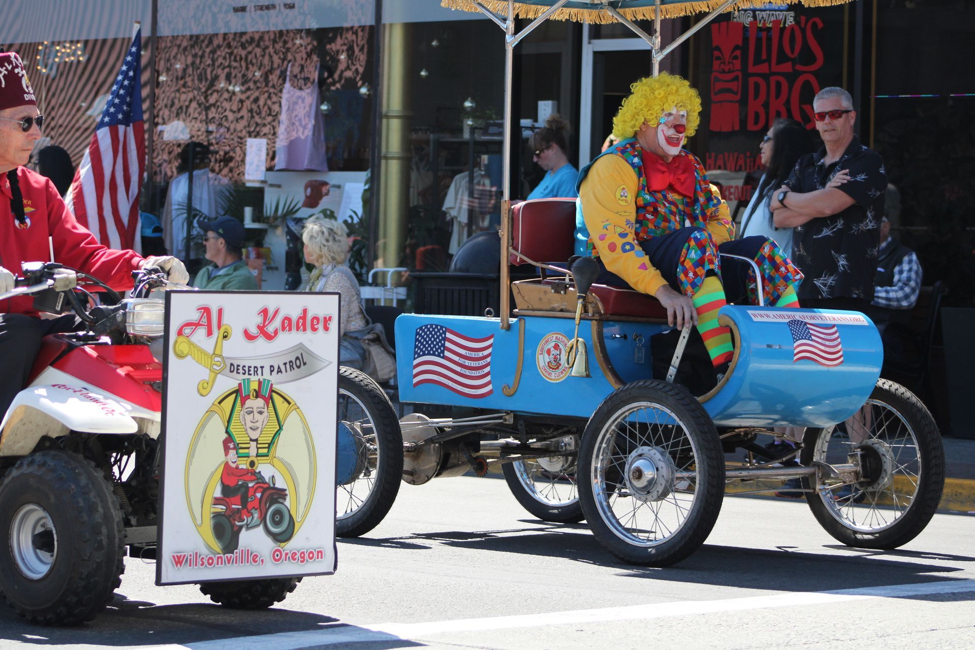 A parade with a sign that says al kader on it