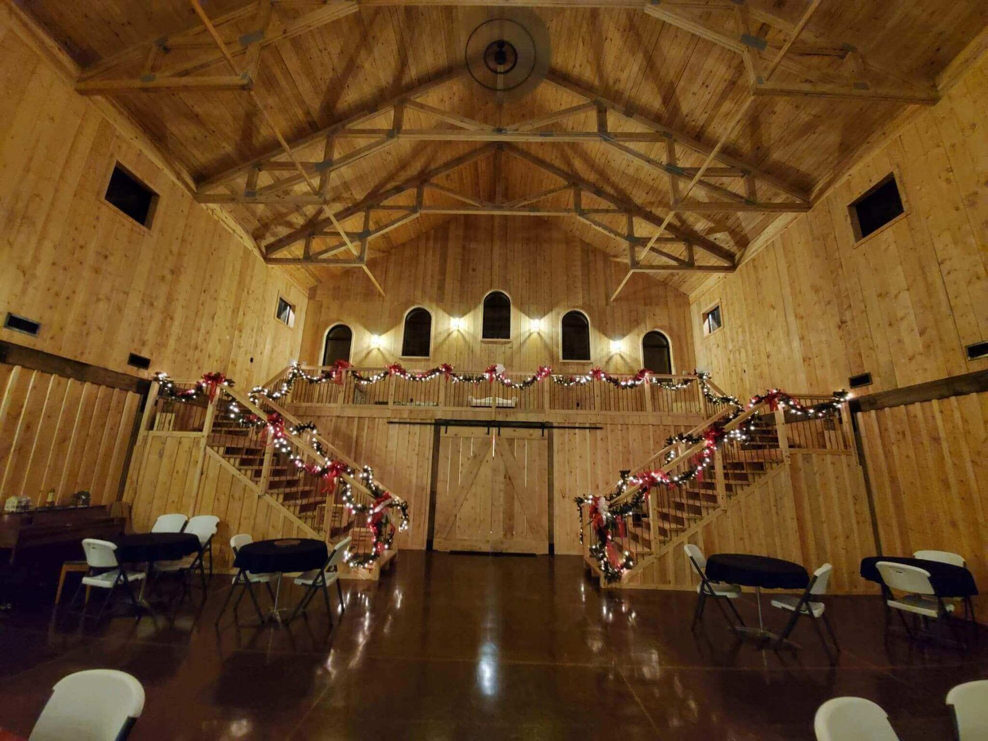 Wooden barn interior, stairs decorated with garland