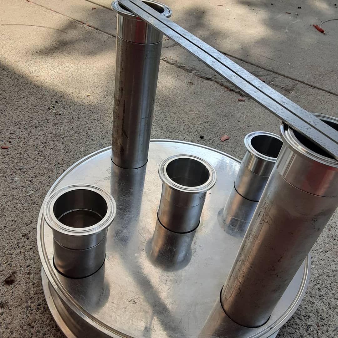 A bunch of metal pipes are sitting on top of a metal plate.
