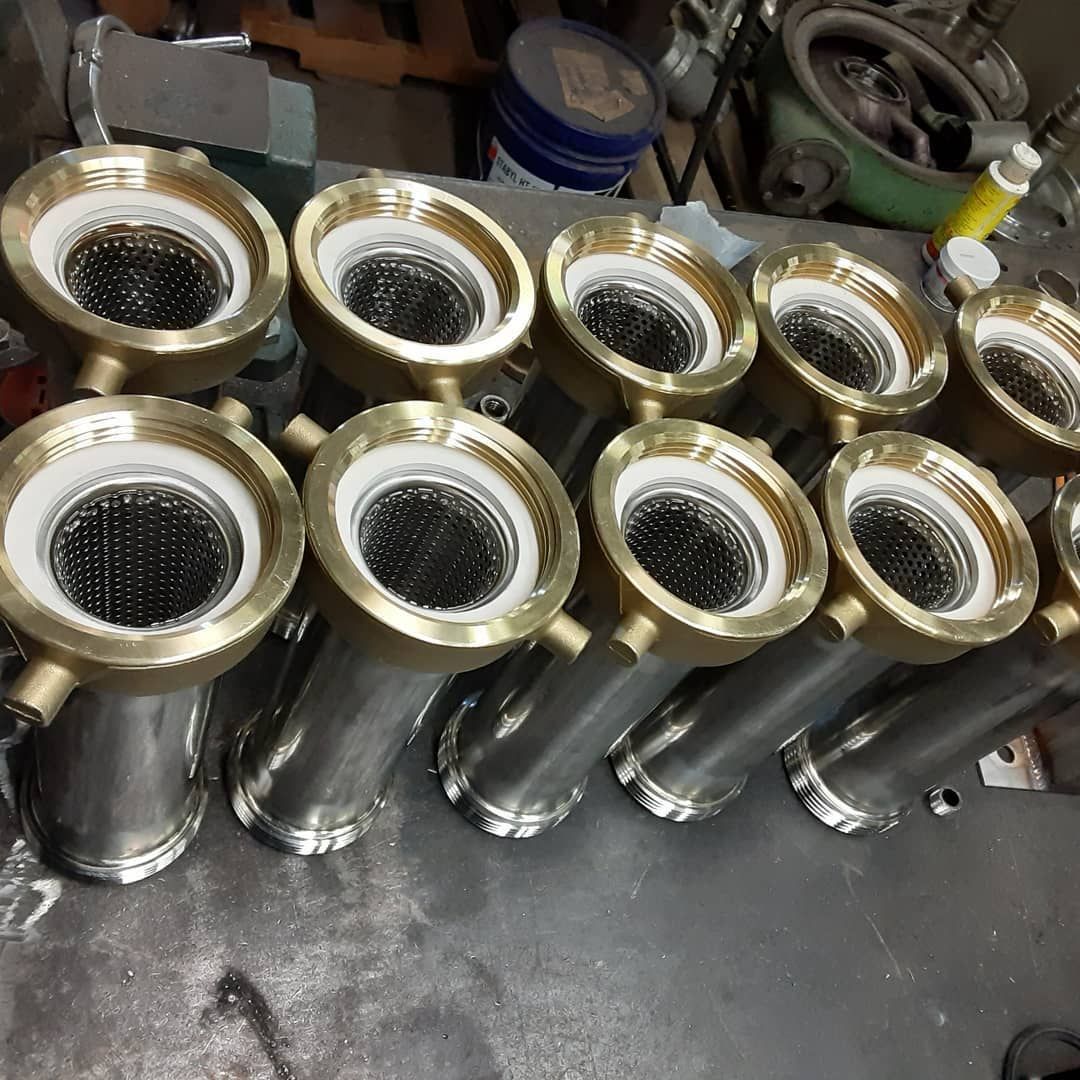A bunch of metal pipes are lined up on a table