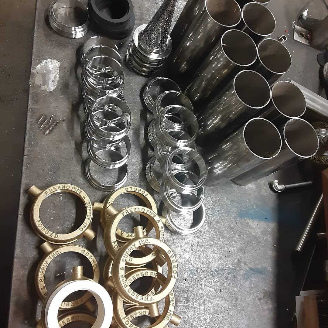 A bunch of metal pipes and rings on a table