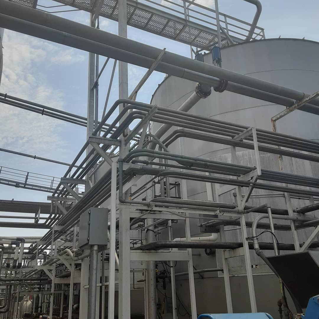 A factory with a lot of pipes going through it