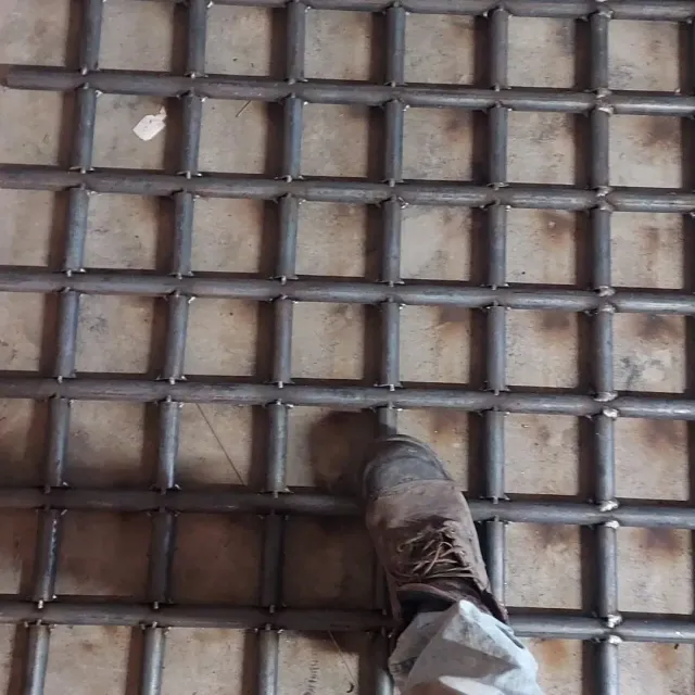 A close up of a metal structure with stairs and pipes