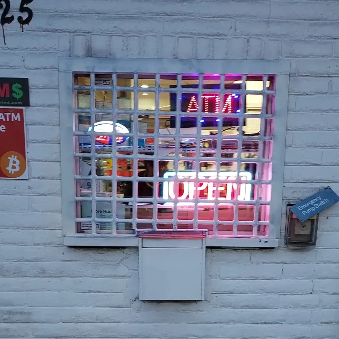 A window with a sign that says atm on it