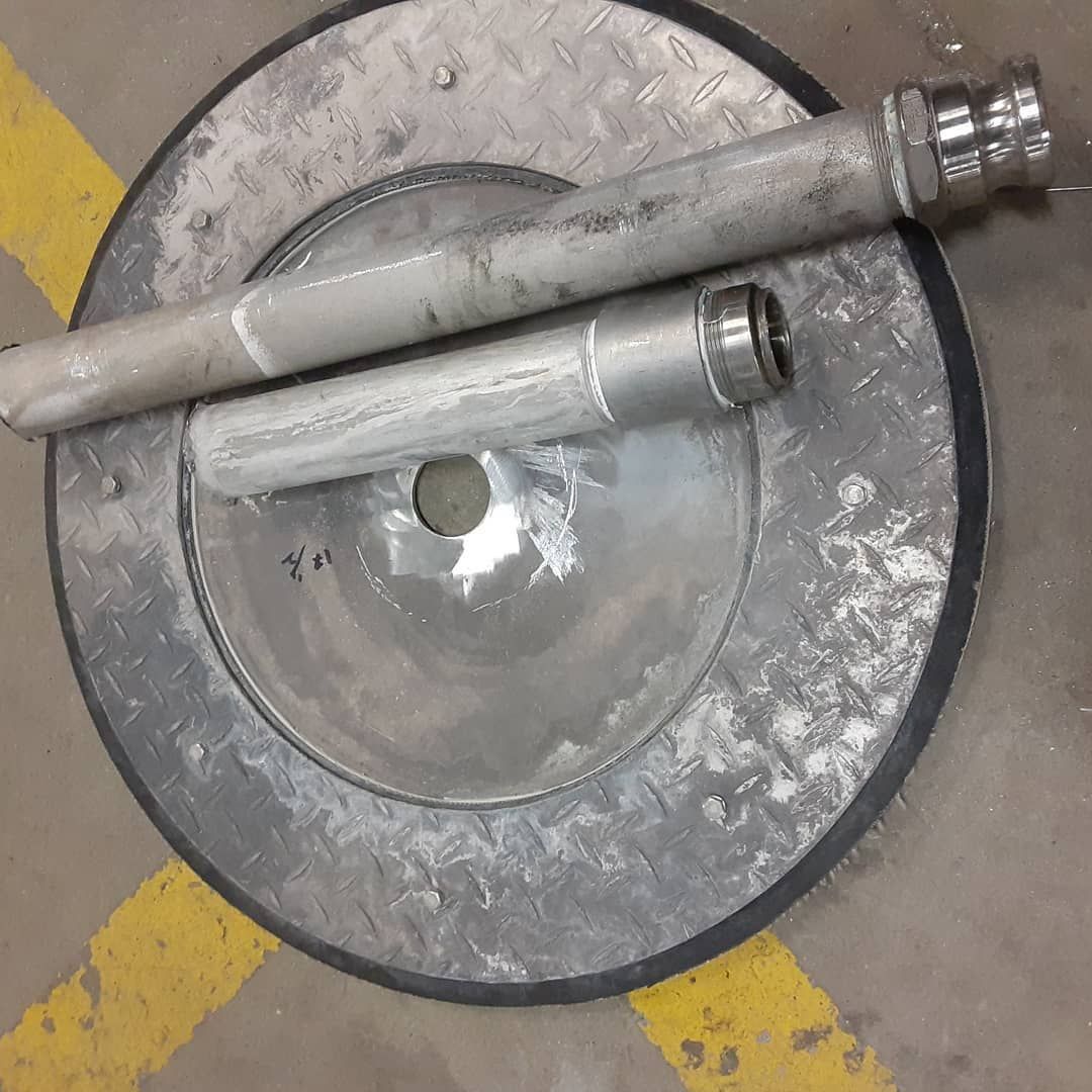 A metal object is sitting on top of a metal plate.
