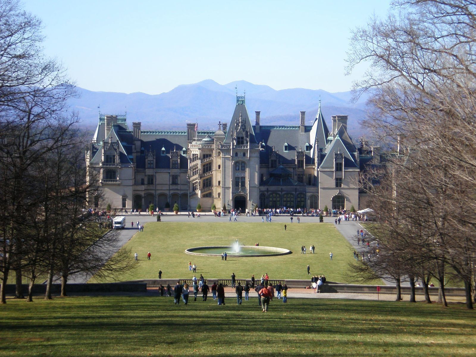 A large building with a fountain in front of it