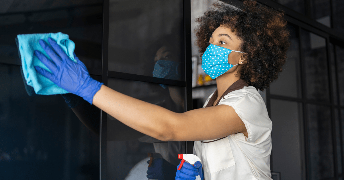 Housekeeeper cleaning window