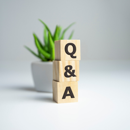 Wooden blocks stacked on top of each other with the words q & a written on them.
