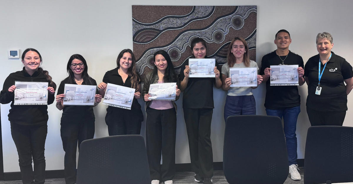 ahs hospitality housekeepers showing their certificates