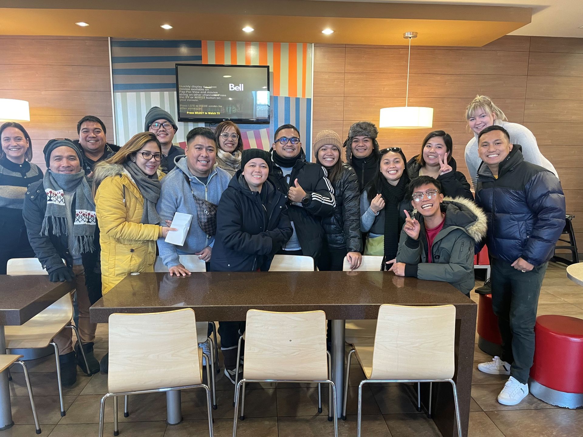 A group of people are posing for a picture in a restaurant.