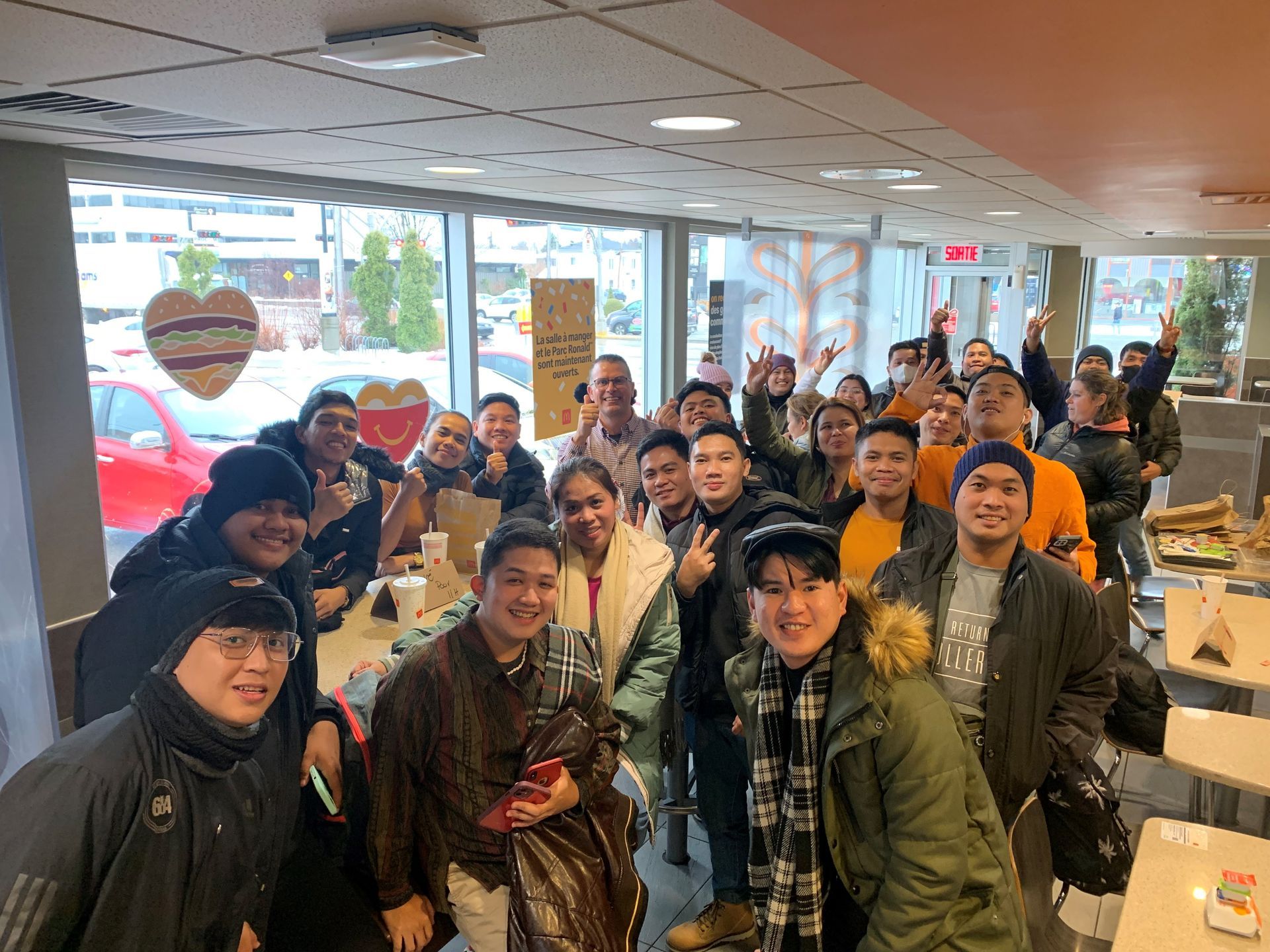 A group of people are posing for a picture in a restaurant.