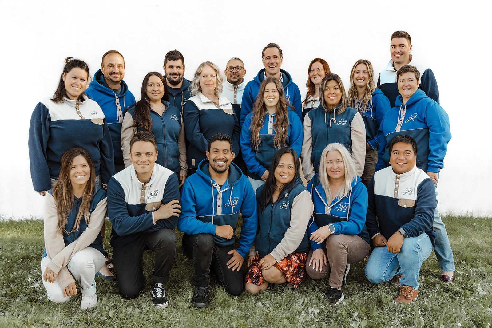 A group of people are posing for a picture in a field.
