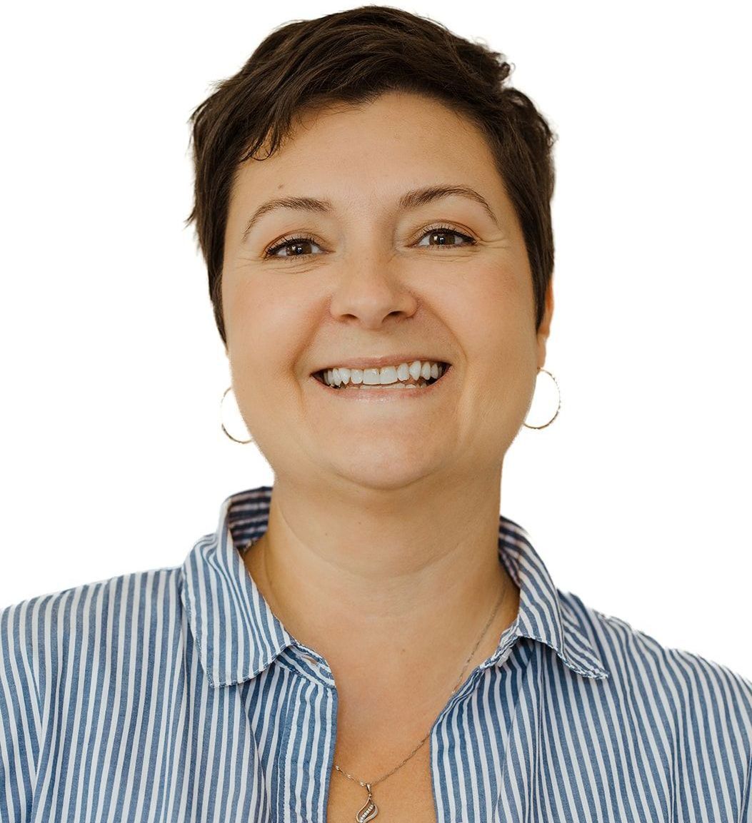 A woman wearing a blue and white striped shirt is smiling