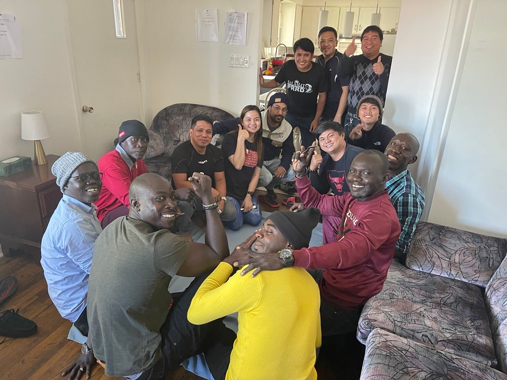 A group of people are posing for a picture in a living room.