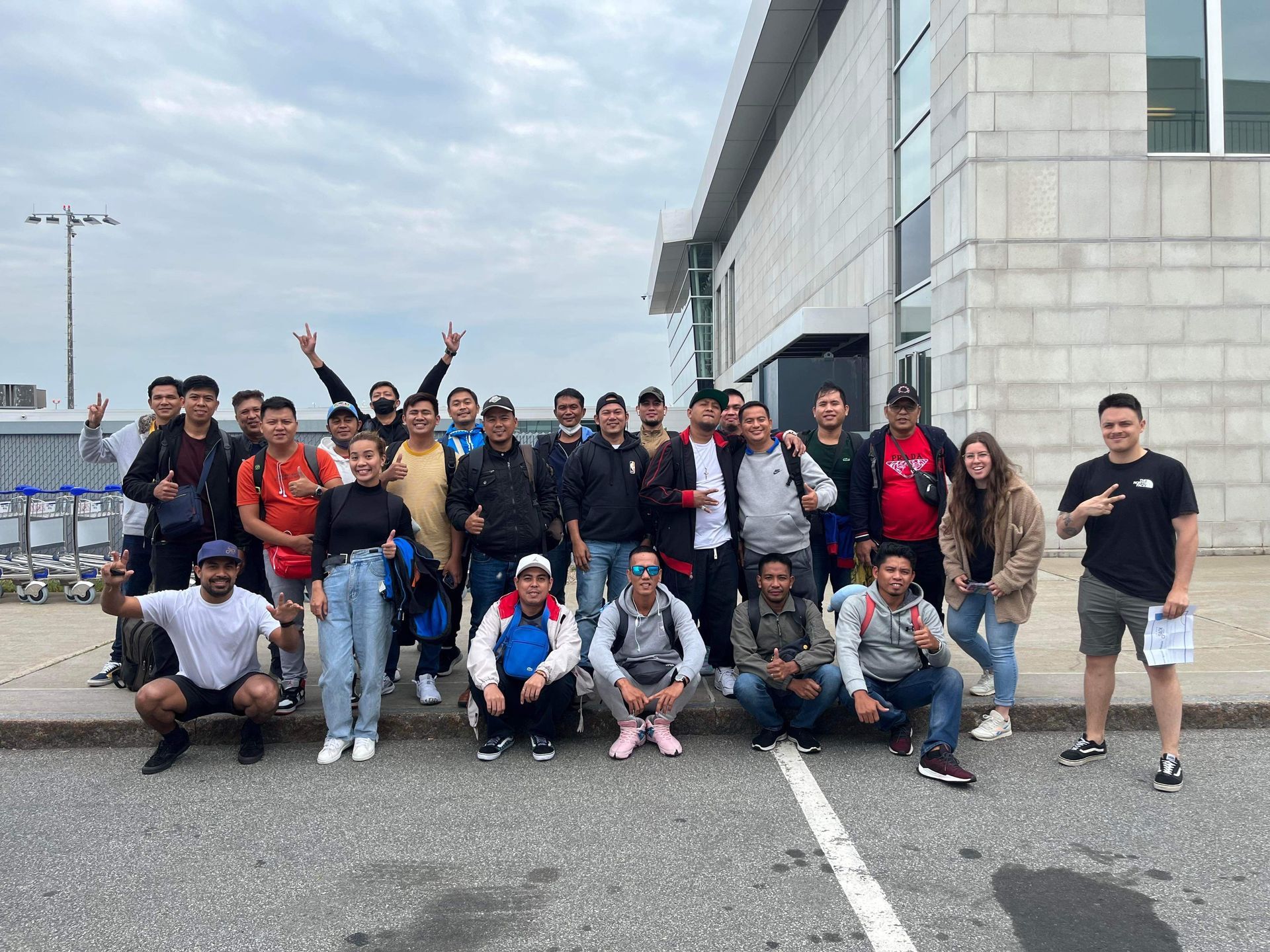 A group of people are posing for a picture in front of a building.
