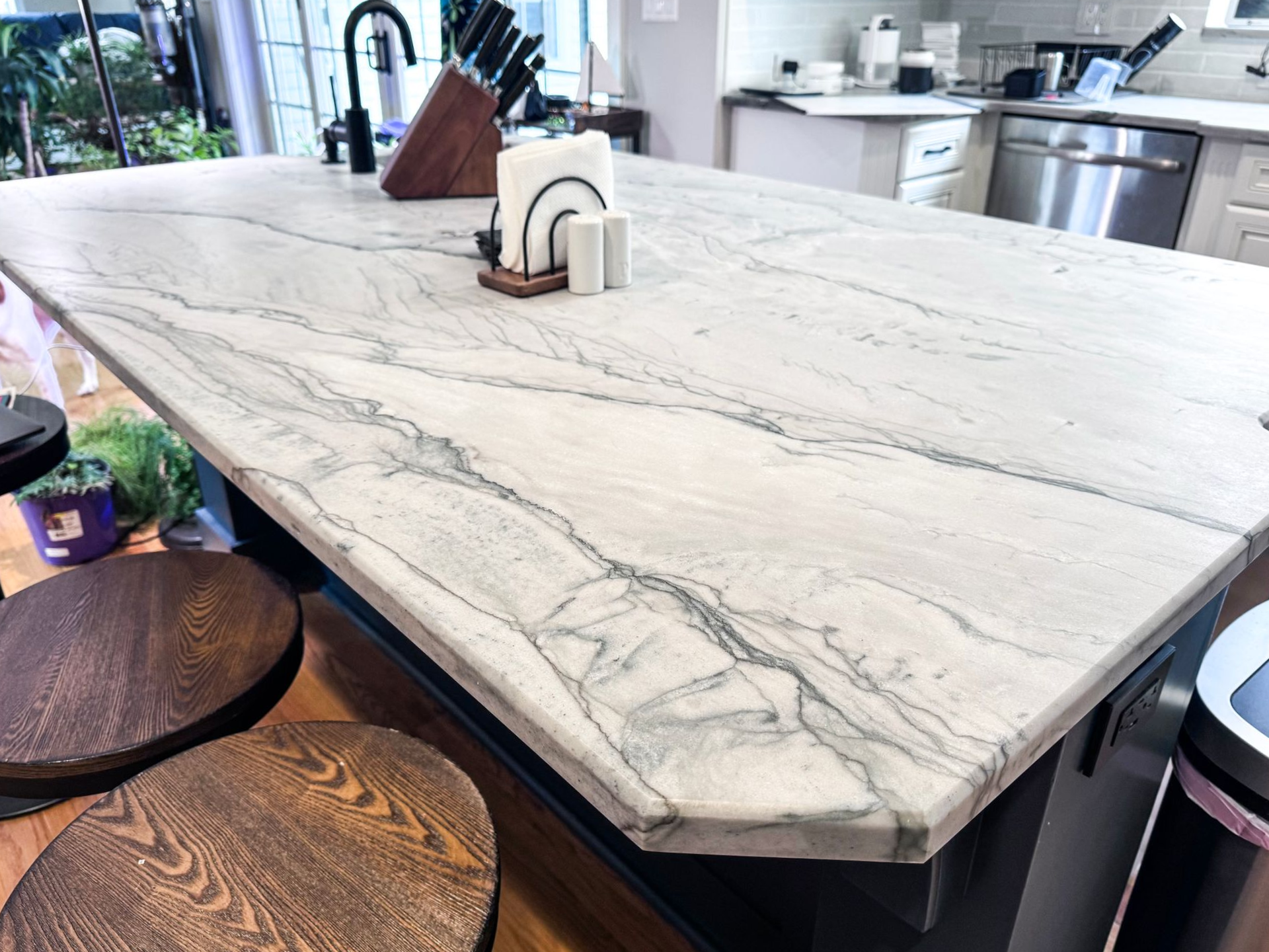 White marble kitchen island with veined surface and built-in sink in a modern kitchen