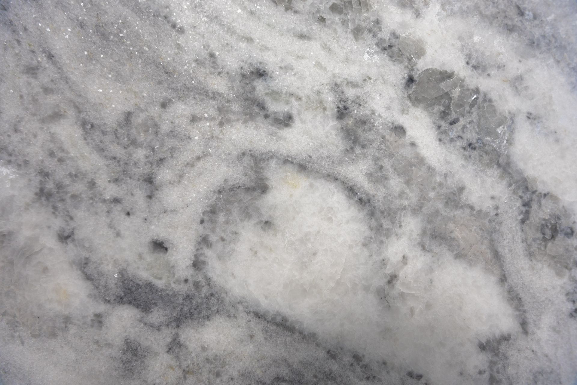 Gray and white marble-like stone surface with cloudy veining