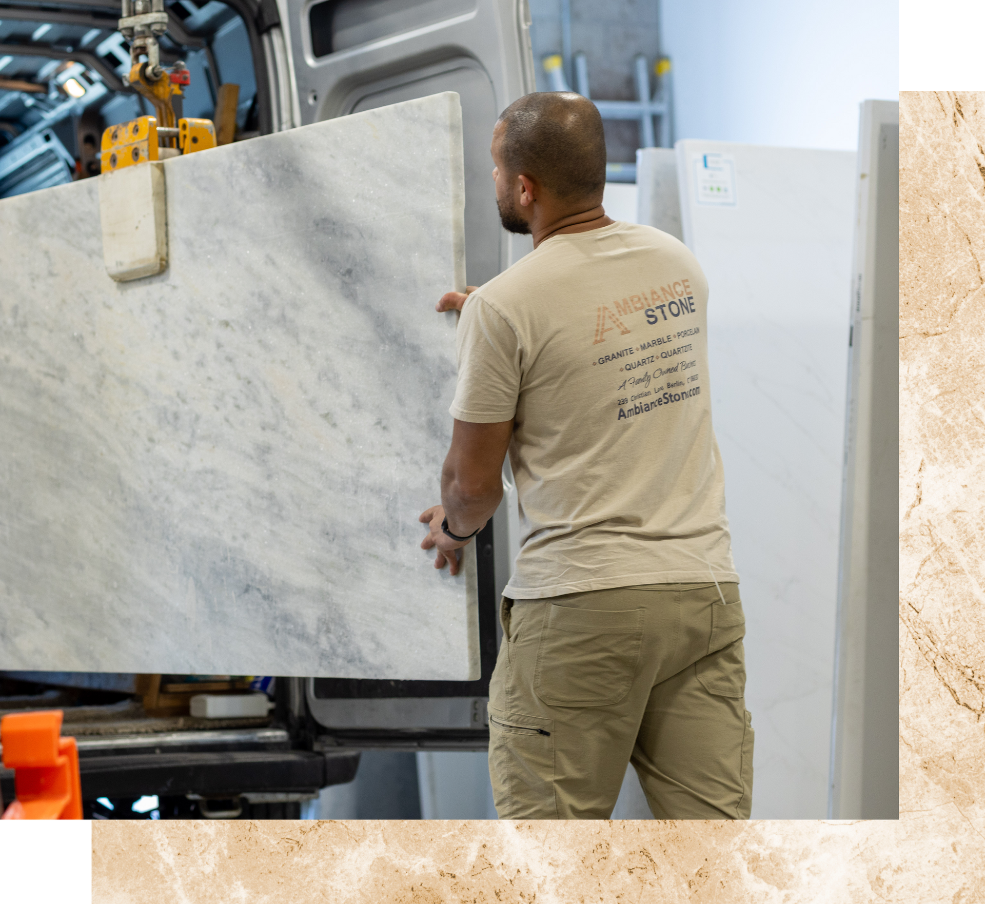Worker moving a large marble slab with a forklift in a warehouse