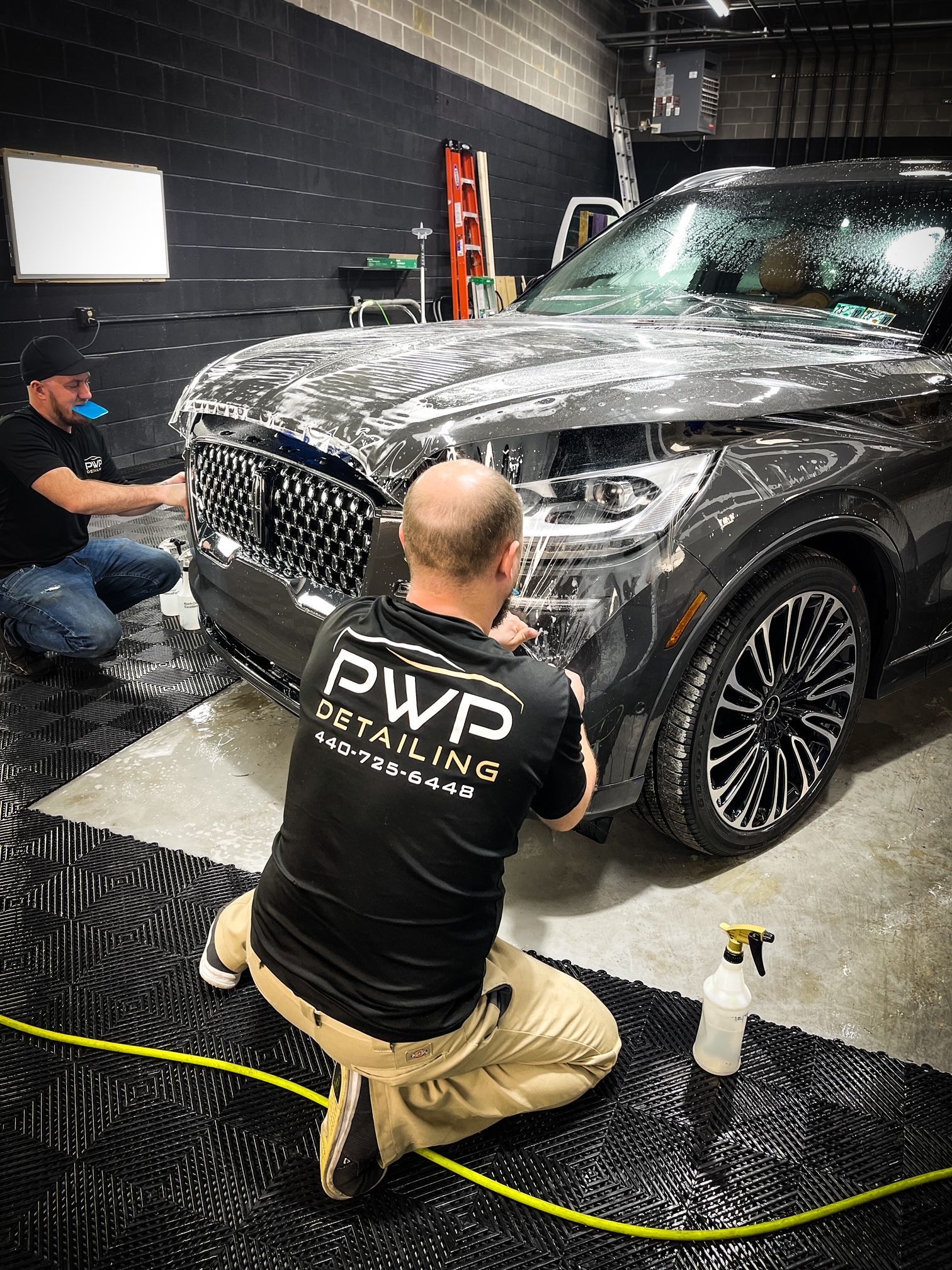 applying paint protection film to the SUV
