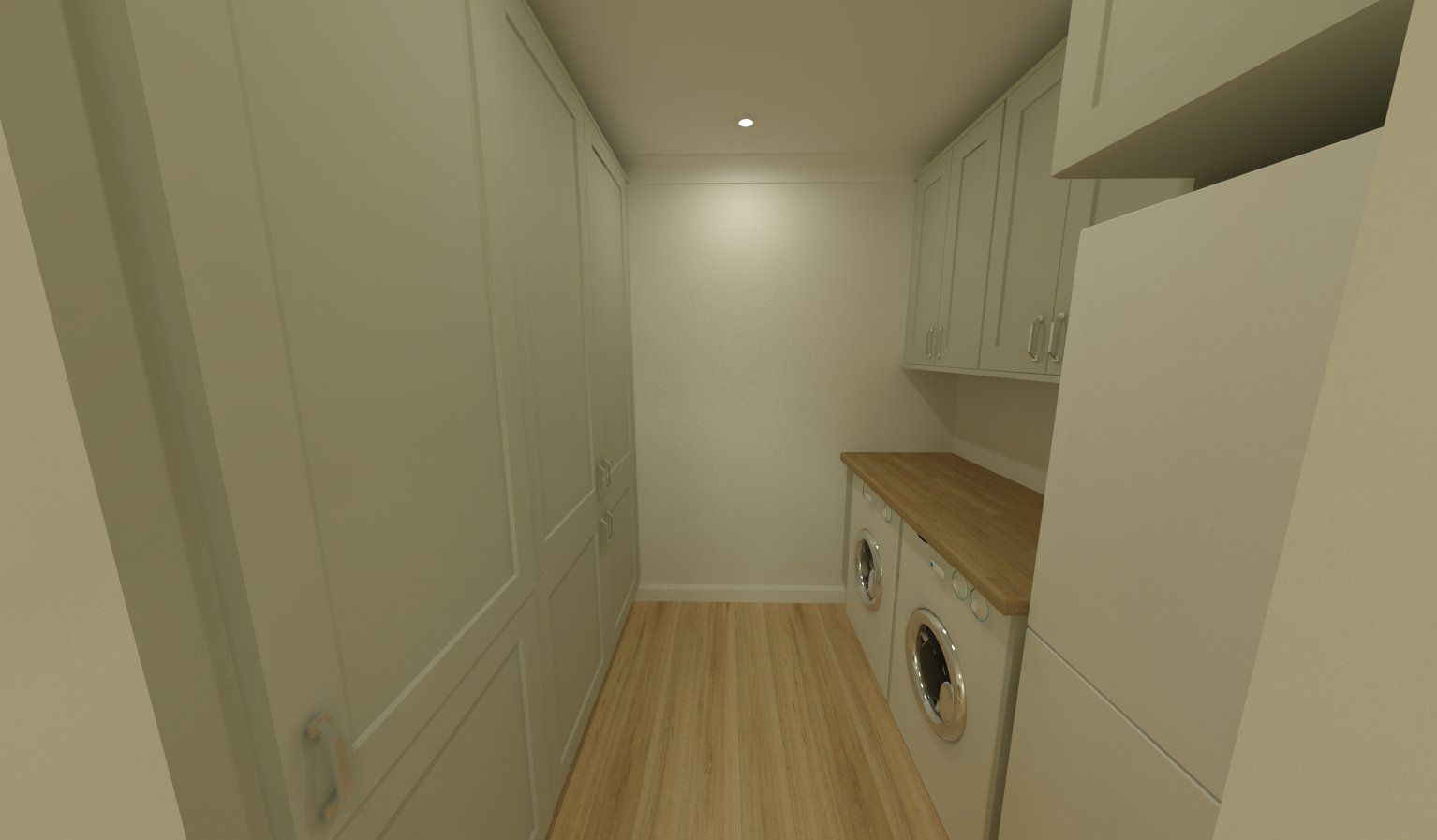 A small, white-walled laundry room with a washer, dryer, and wooden countertop.