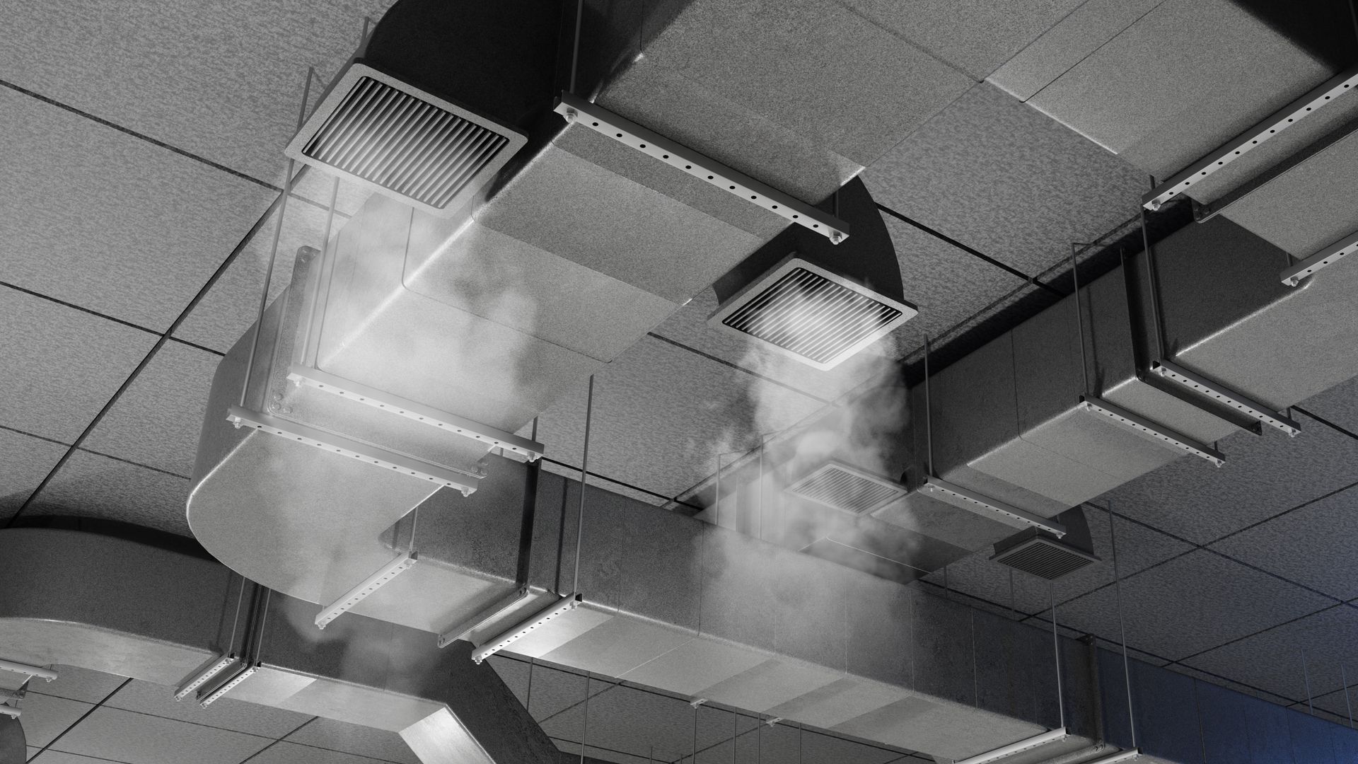 Exposed silver HVAC ducts and hanging wires on a white ceiling, with a red pipe above.
