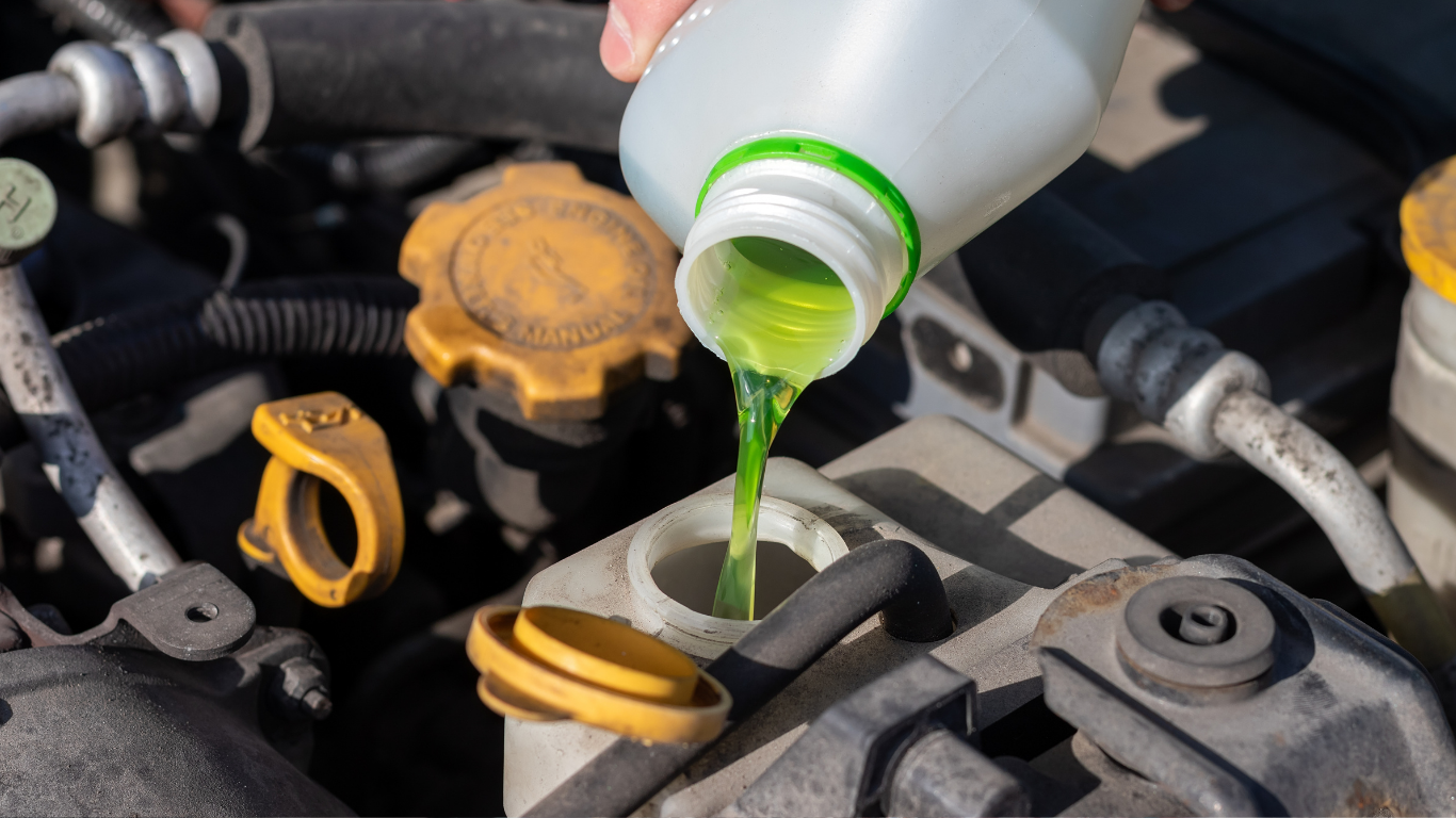 Technician performing coolant flush service in Prescott, AZ