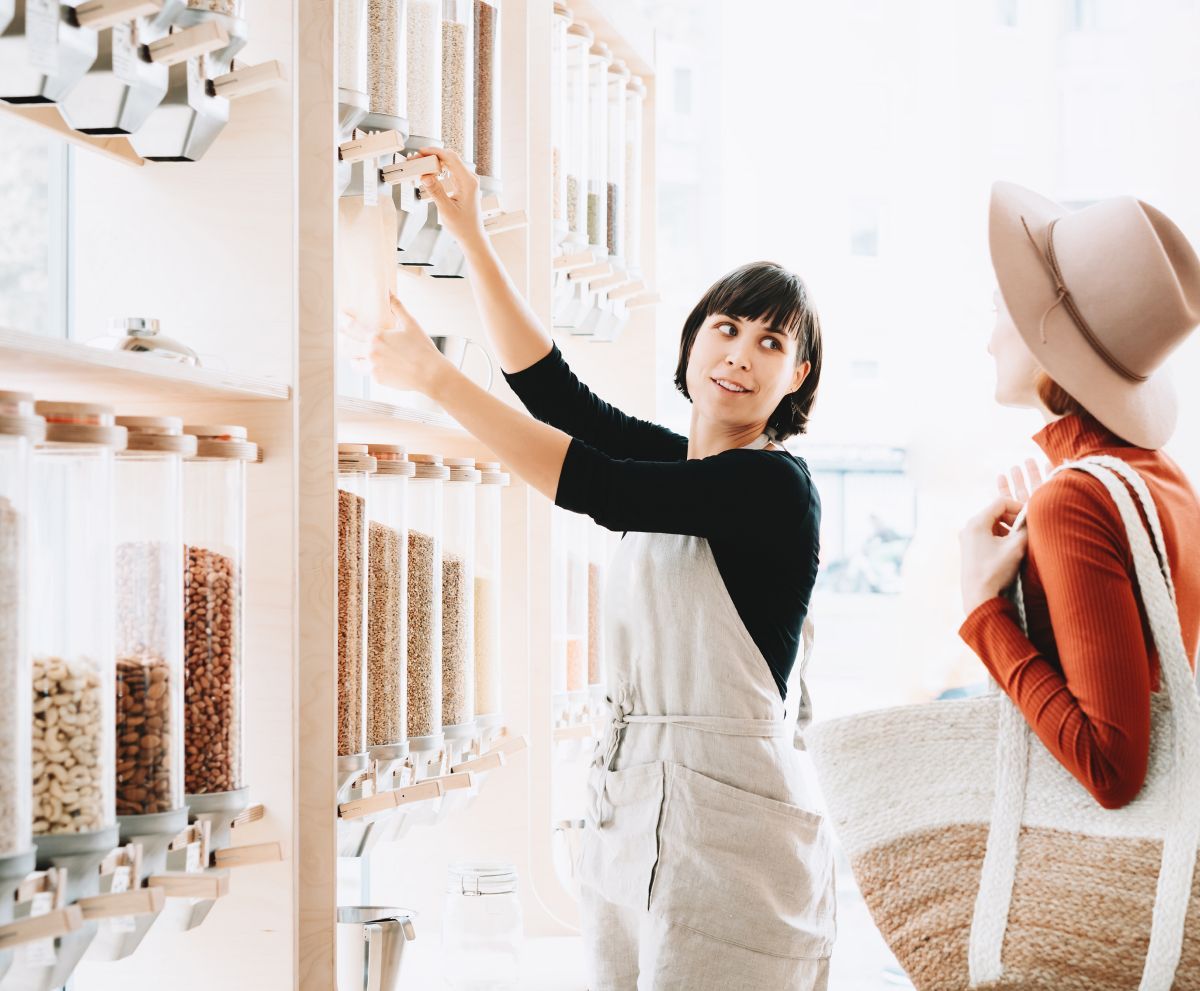 A woman is standing next to another woman in a store.