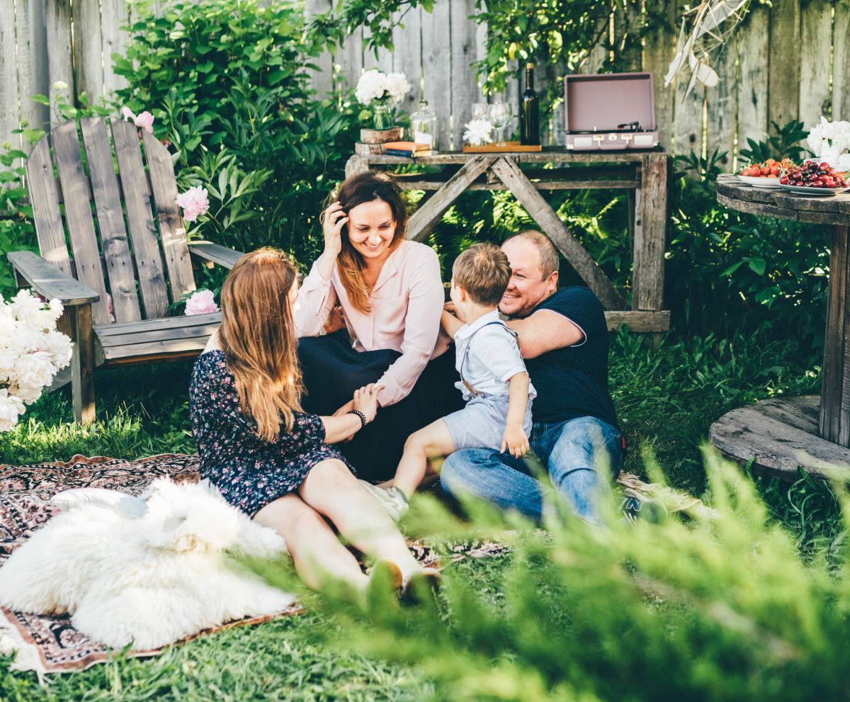 A family is having a picnic in their backyard.