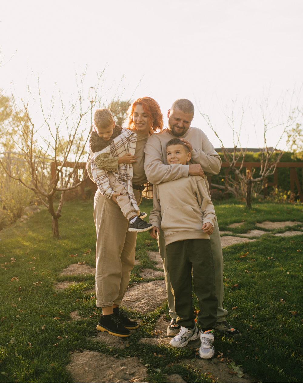 A family is posing for a picture in a garden.