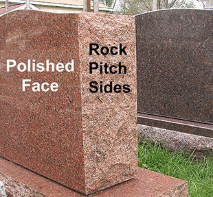 Red granite tombstone with polished face and rock pitch sides, outdoors.