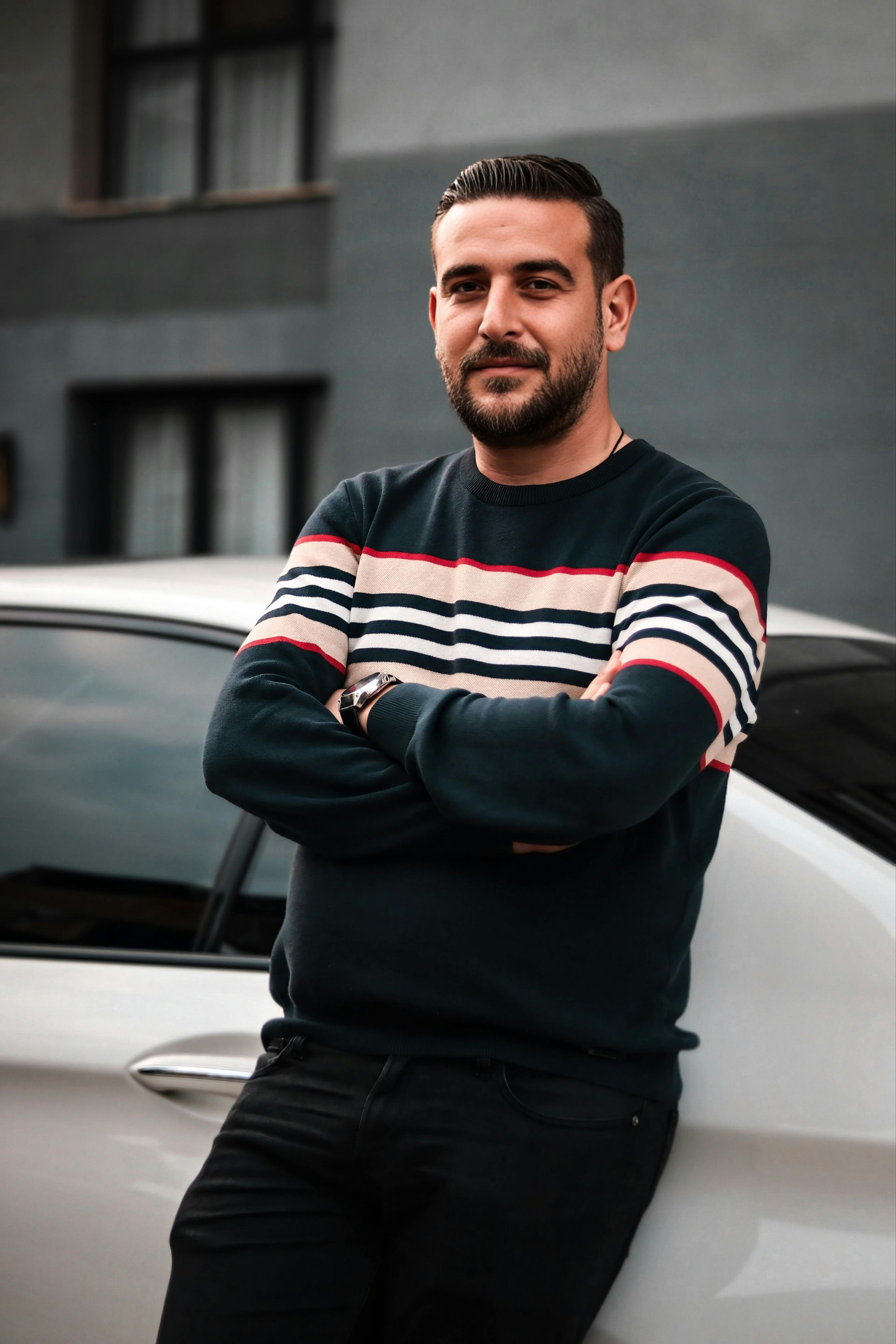 man leaning against a car