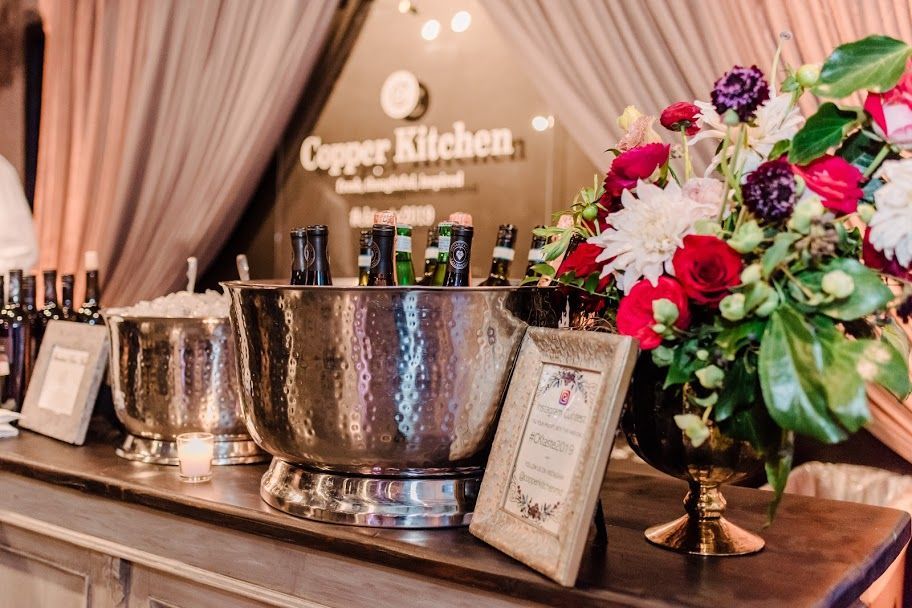 Corporate catering setup with formal table settings, glassware, and professional event service