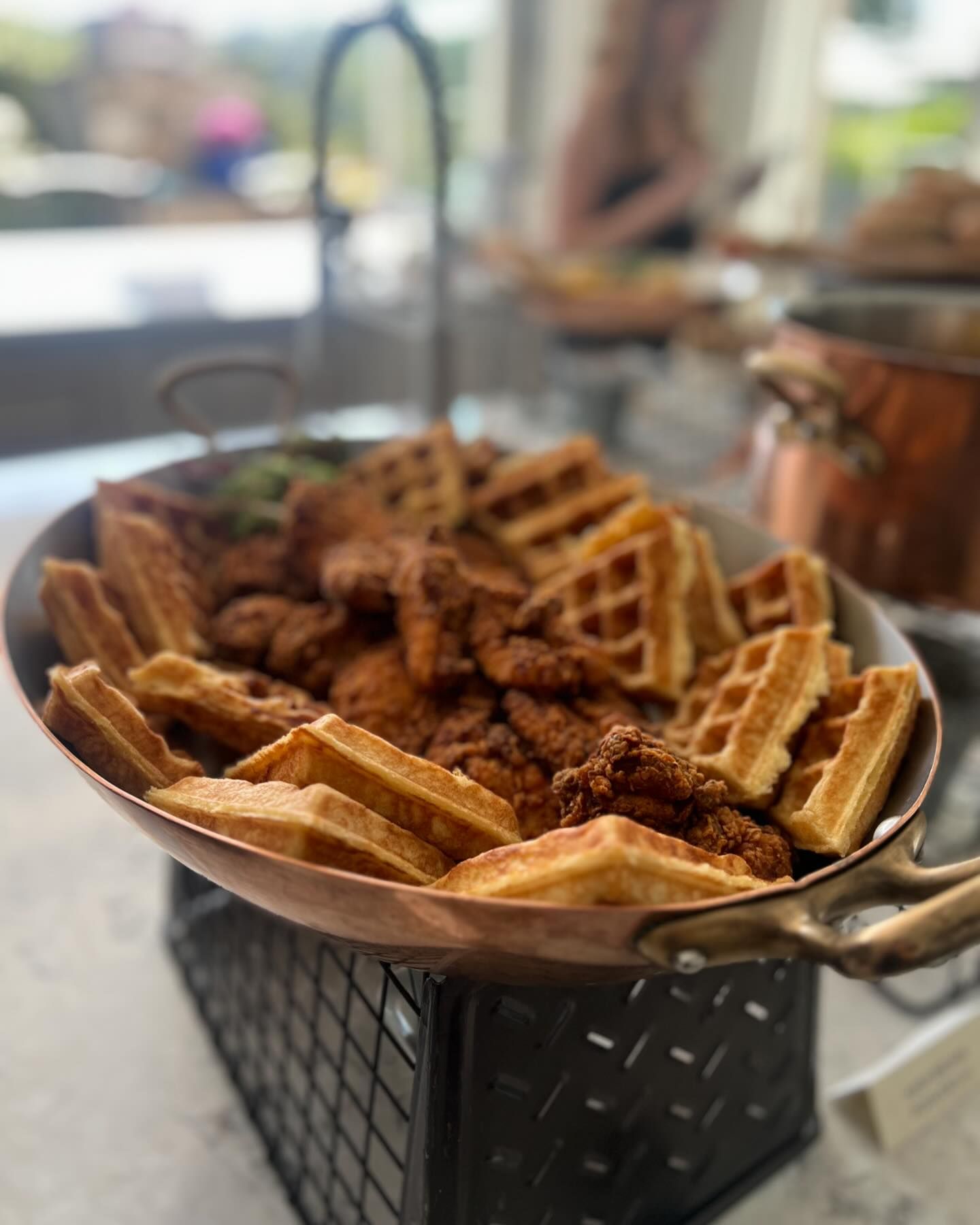 Chicken and waffles served on a copper platter, atop a wire stand, at a corporate catered breakfast in Maryland