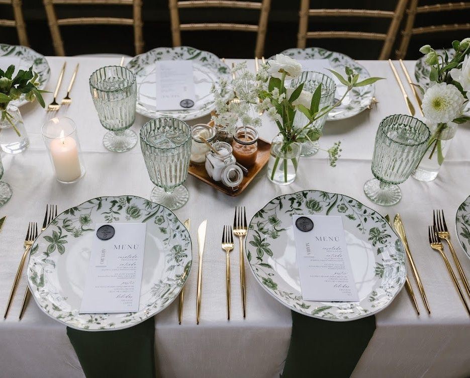 Corporate catering setup with formal table settings, glassware, and professional event service