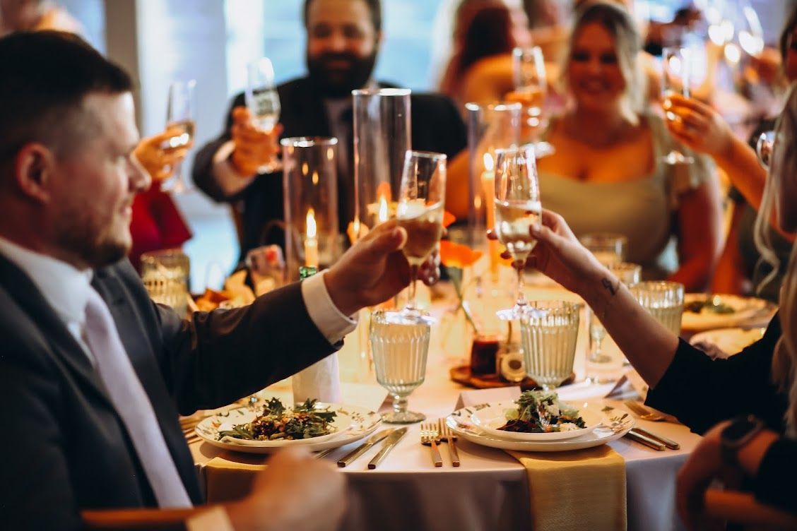 A person serving an assortment of appetizers on wooden platters during an outdoor event.