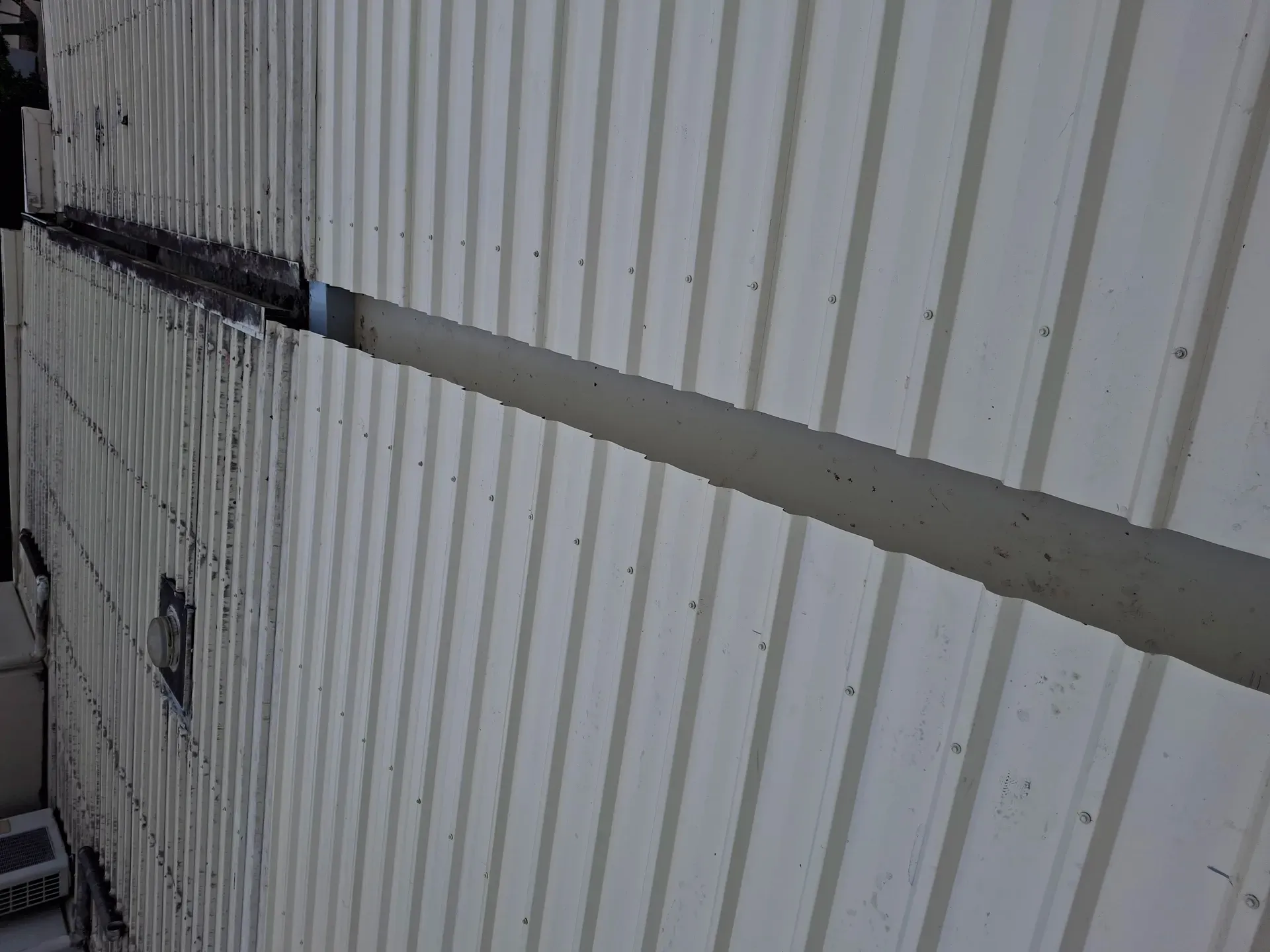 Beige corrugated metal roof with a long seam.