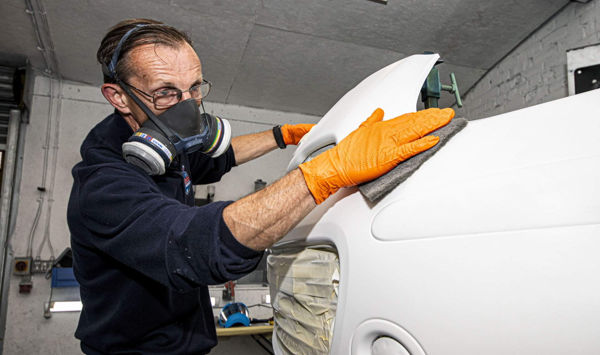mechanic fitting a body panel for respray