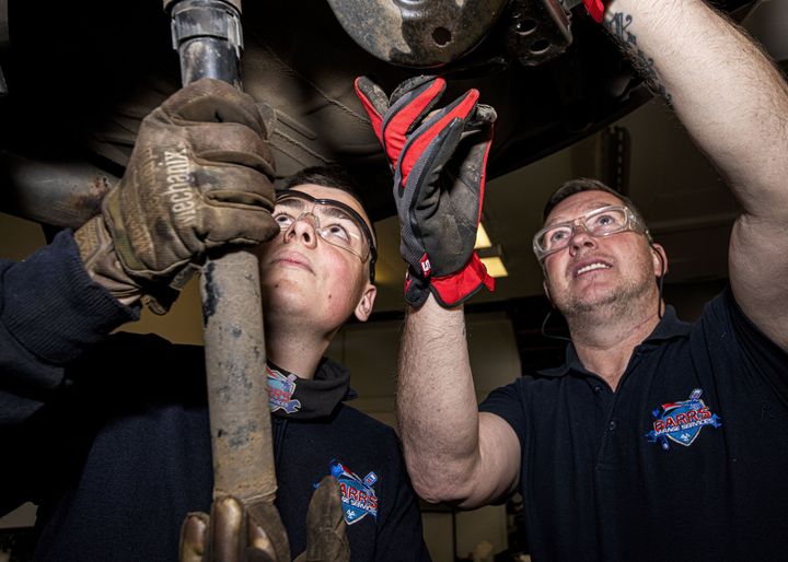 mechanics working on a car