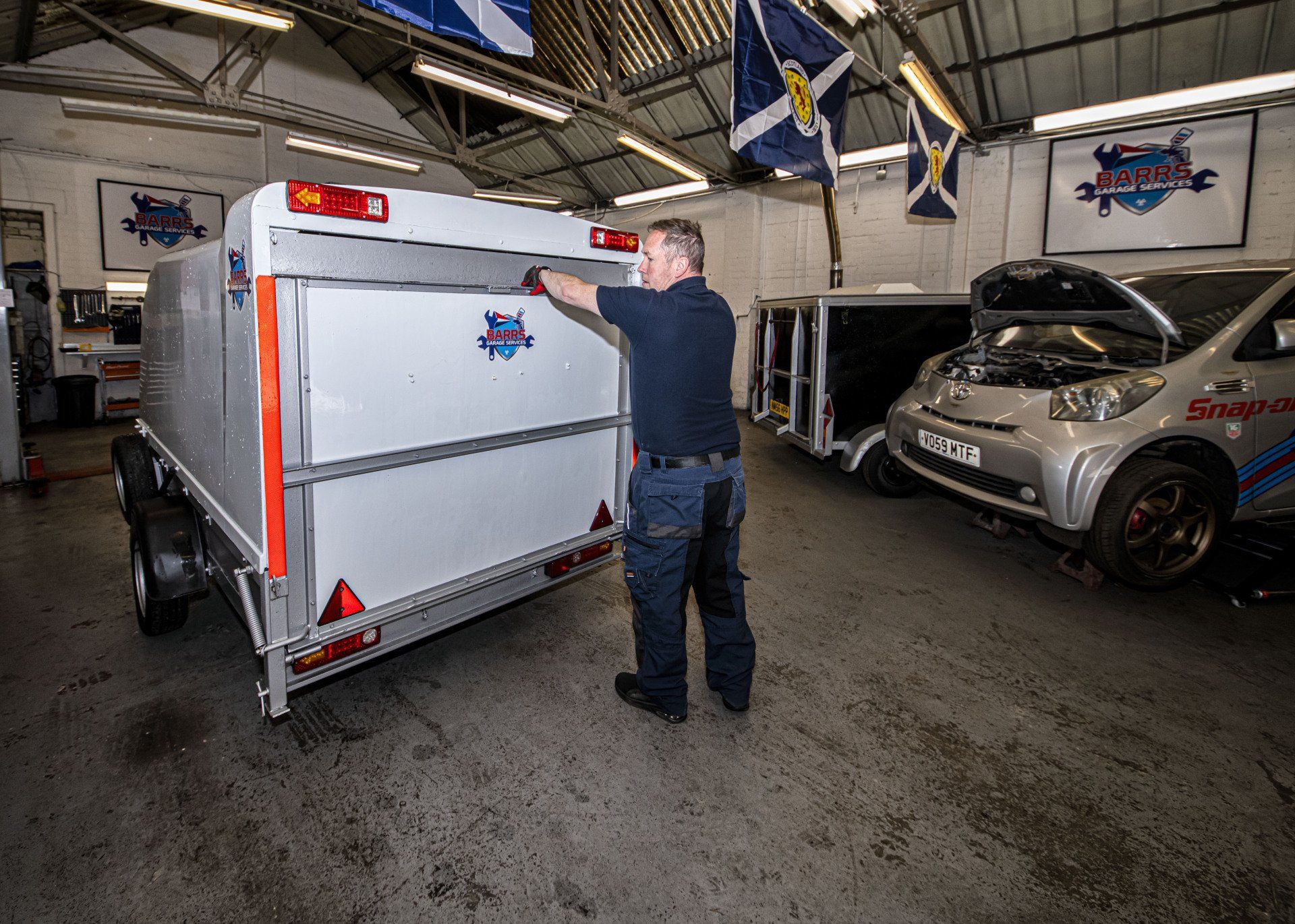 mechanic closing motorbike trailer