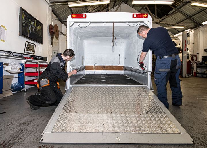 mechanics with motorbike trailer