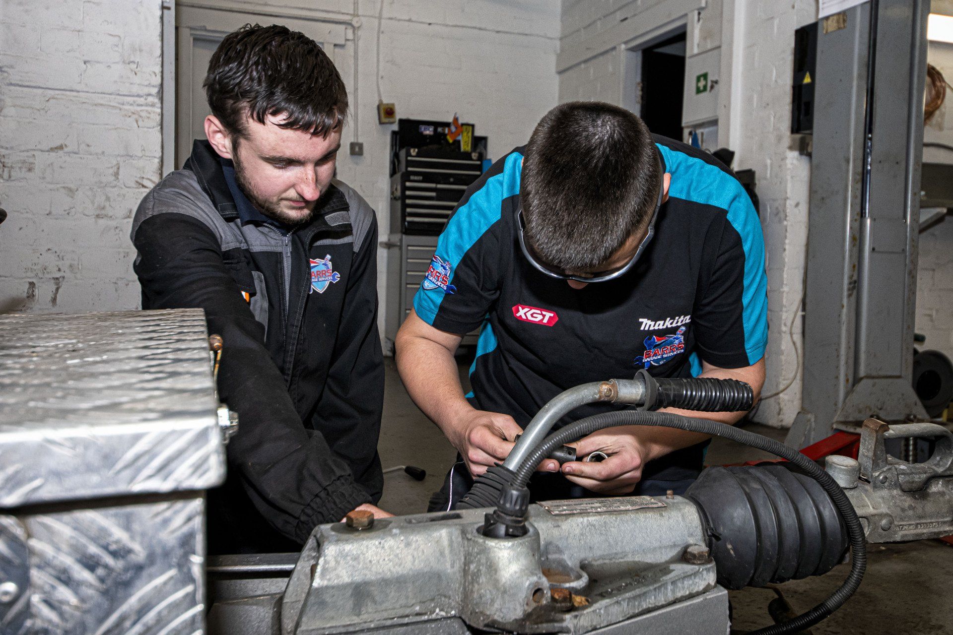 mechanic working on trailer hitch
