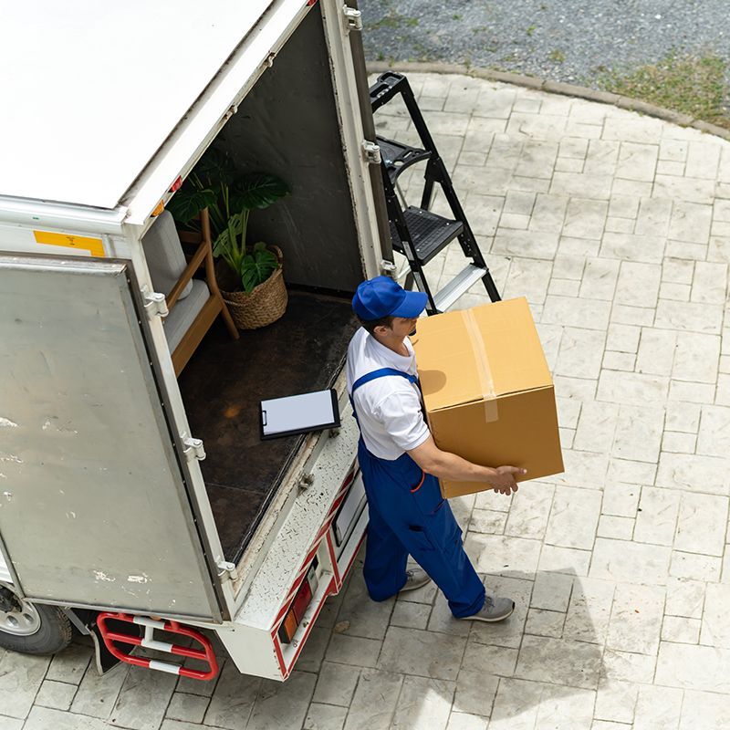 Man Holding Large Brown Box