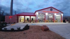 A picture of a Highlands Fire Station lit up at night.