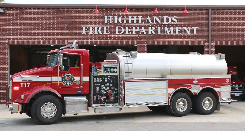 A red fire truck is parked in front of the Highlands fire department