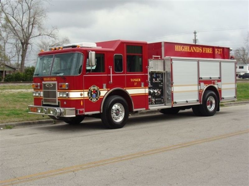 A red Highlands fire truck is parked on the side of the road