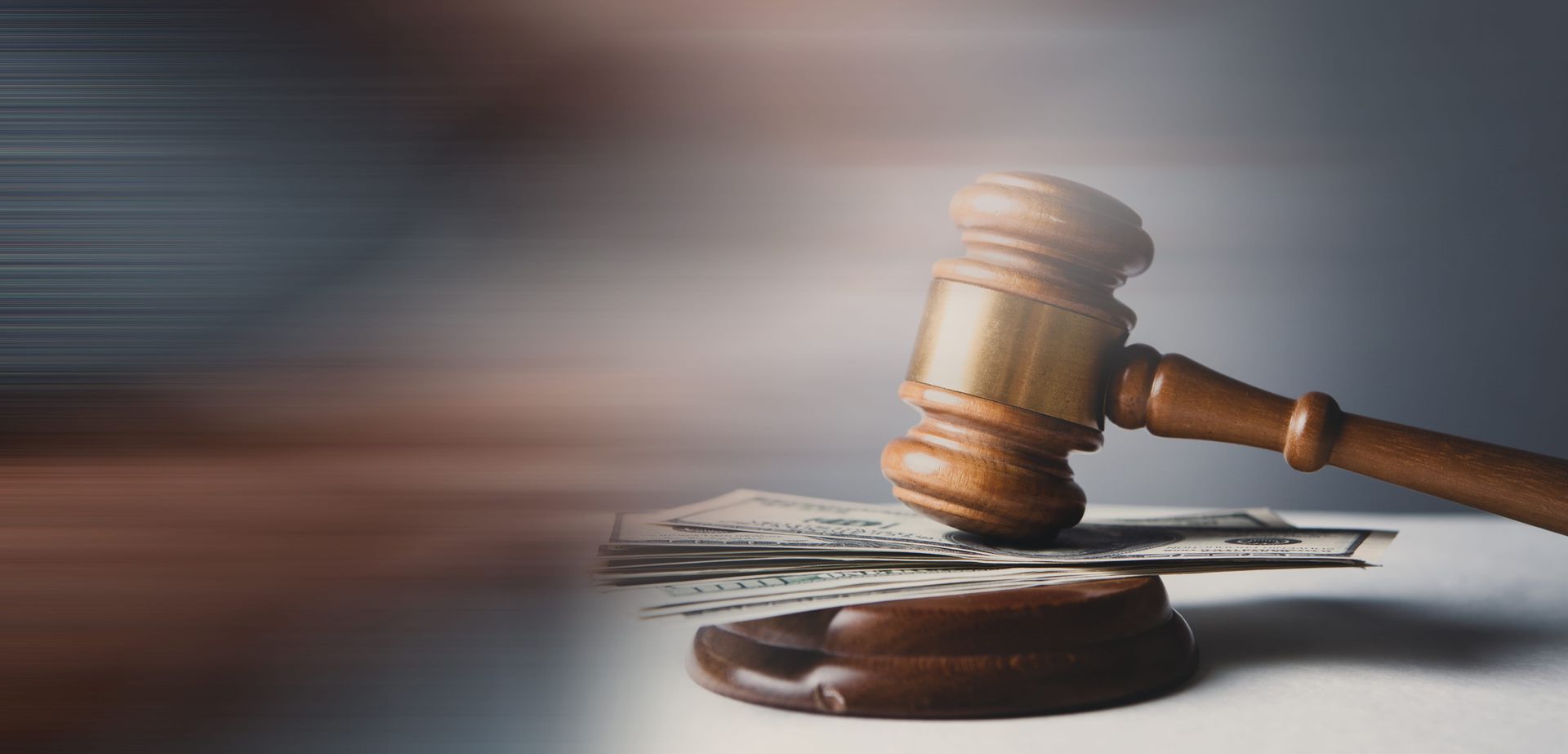 Judge’s gavel resting on a sound block, with motion blur in the background