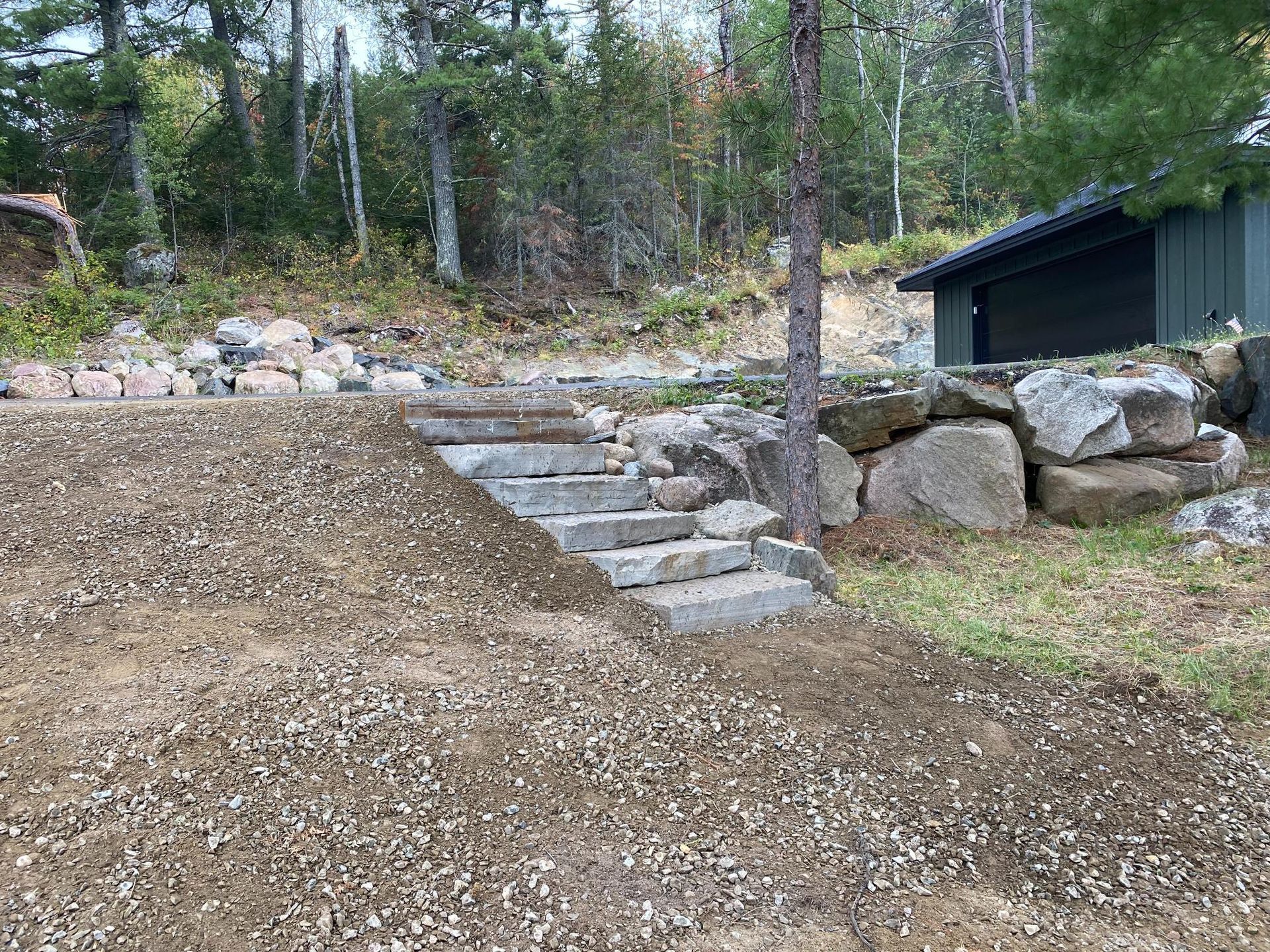 A set of stairs leading up to a house in the woods.