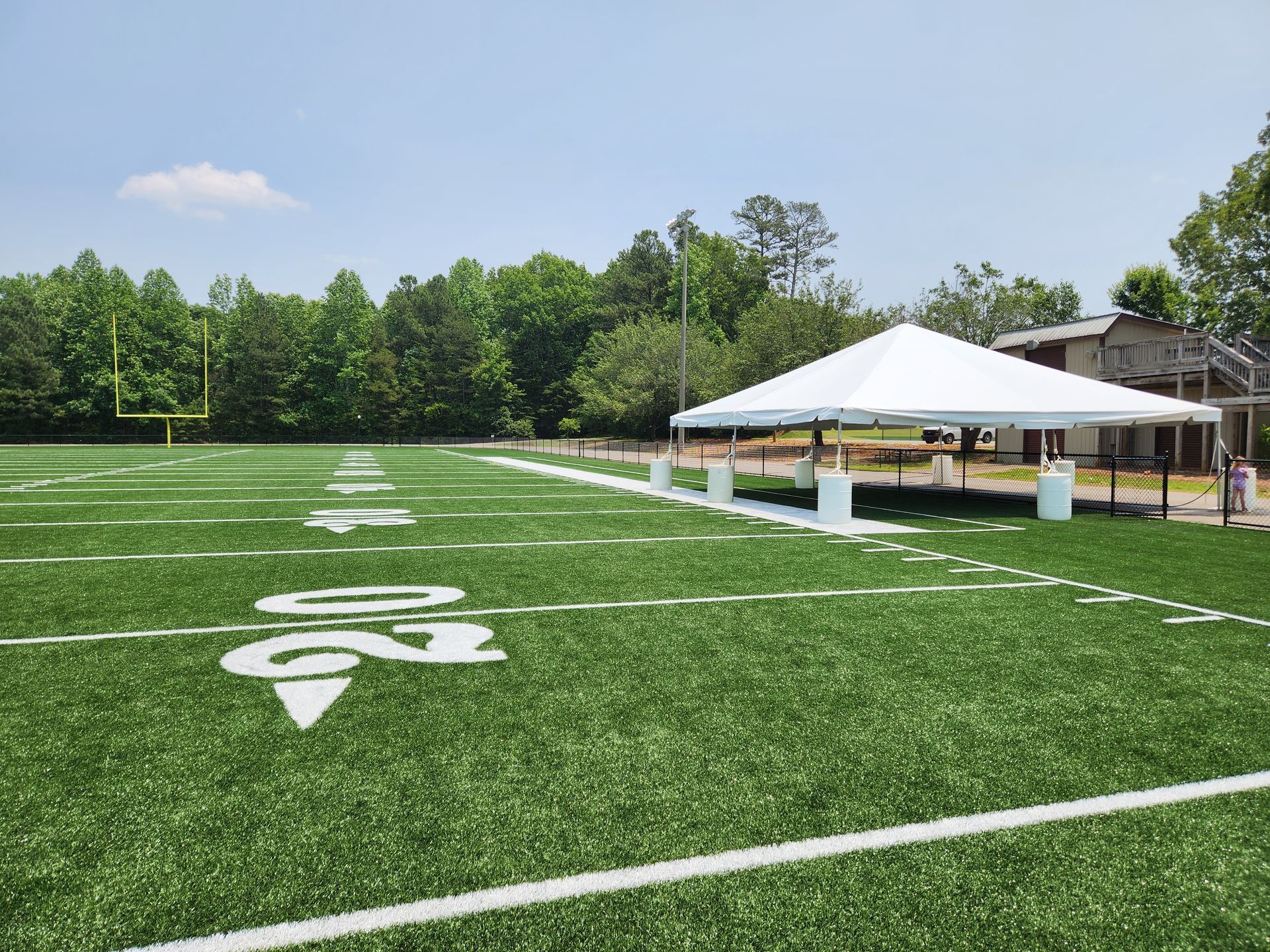 A football field with a white tent on top of it